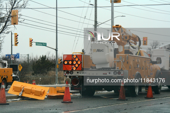 Workers install new traffic lights in Mississauga, Ontario, Canada, on December 4, 2024. 