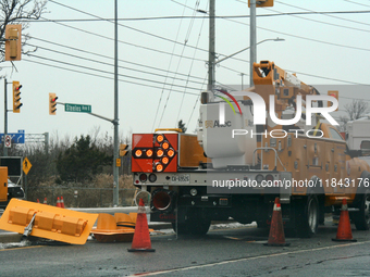 Workers install new traffic lights in Mississauga, Ontario, Canada, on December 4, 2024. (