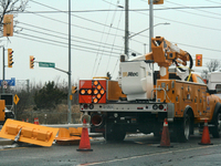 Workers install new traffic lights in Mississauga, Ontario, Canada, on December 4, 2024. (