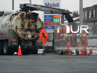 Workers use a vacuum truck to unclog a sewer drain in Mississauga, Ontario, Canada, on December 4, 2024. (