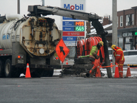 Workers use a vacuum truck to unclog a sewer drain in Mississauga, Ontario, Canada, on December 4, 2024. (