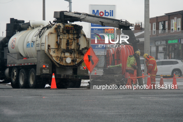 Workers use a vacuum truck to unclog a sewer drain in Mississauga, Ontario, Canada, on December 4, 2024. 