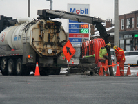 Workers use a vacuum truck to unclog a sewer drain in Mississauga, Ontario, Canada, on December 4, 2024. (