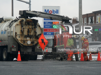 Workers use a vacuum truck to unclog a sewer drain in Mississauga, Ontario, Canada, on December 4, 2024. (