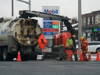 Workers use a vacuum truck to unclog a sewer drain in Mississauga, Ontario, Canada, on December 4, 2024. (