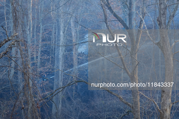 The Washington DC Fire Department battles a brush fire in Rock Creek Park, a National Park in Washington DC, on December 7, 2024. The fire b...