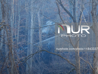 The Washington DC Fire Department battles a brush fire in Rock Creek Park, a National Park in Washington DC, on December 7, 2024. The fire b...