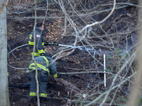 The Washington DC Fire Department battles a brush fire in Rock Creek Park, a National Park in Washington DC, on December 7, 2024. The fire b...