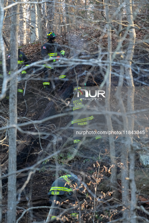 The Washington DC Fire Department battles a brush fire in Rock Creek Park, a National Park in Washington DC, on December 7, 2024. The fire b...