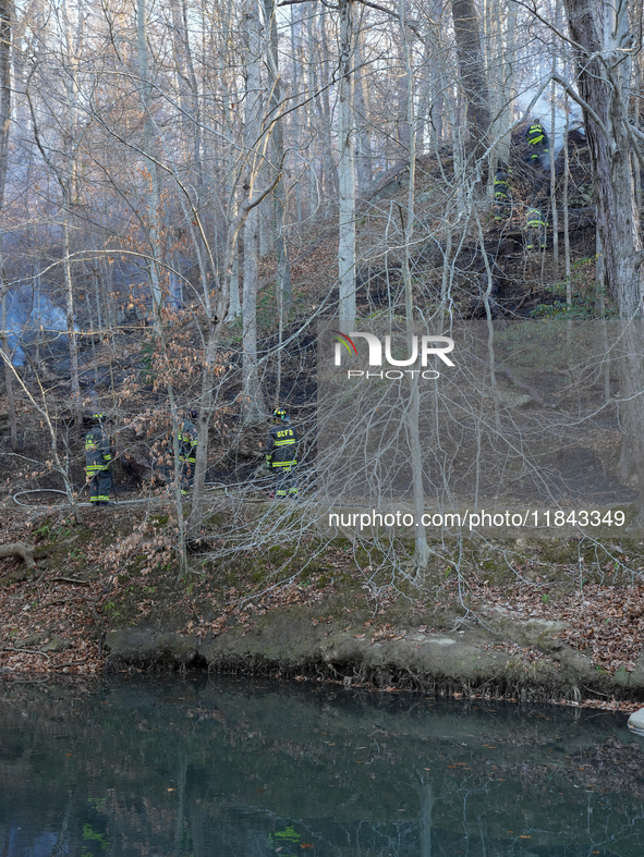 The Washington DC Fire Department battles a brush fire in Rock Creek Park, a National Park in Washington DC, on December 7, 2024. The fire b...