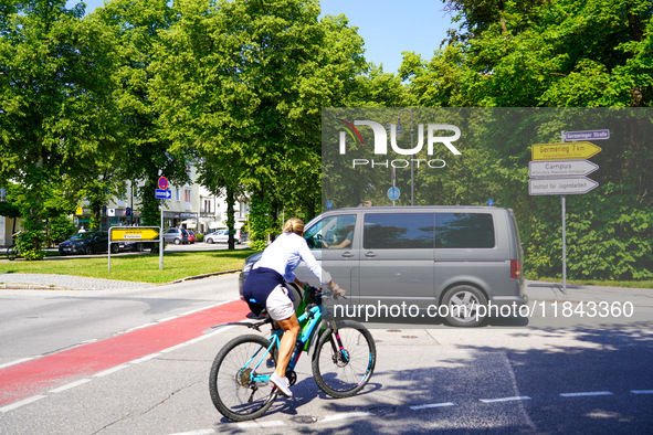 A German Crime Police van is on a mission with its flashing blue lights in Gauting, Bavaria, on July 5, 2022. A cyclist crosses the street n...