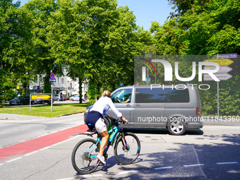 A German Crime Police van is on a mission with its flashing blue lights in Gauting, Bavaria, on July 5, 2022. A cyclist crosses the street n...