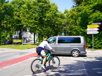 A German Crime Police van is on a mission with its flashing blue lights in Gauting, Bavaria, on July 5, 2022. A cyclist crosses the street n...