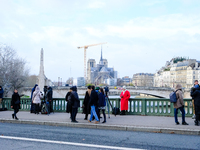 Television journalists film Notre Dame Cathedral. (