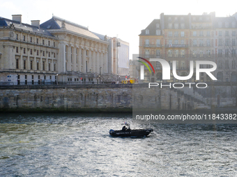 A police prefecture boat patrols the Seine around the Ile de la Cite, where Notre-Dame Cathedral is located. (