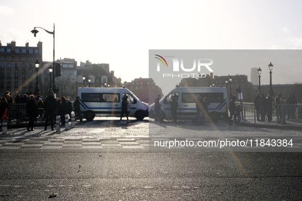 Police trucks block access to the quays leading to the Ile de la Cite, where Notre-Dame Cathedral is located. 