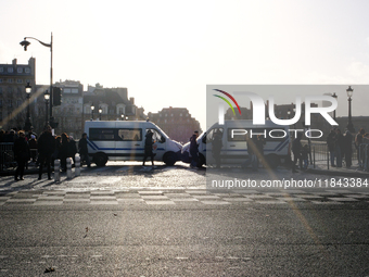 Police trucks block access to the quays leading to the Ile de la Cite, where Notre-Dame Cathedral is located. (