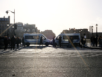 Police trucks block access to the quays leading to the Ile de la Cite, where Notre-Dame Cathedral is located. (