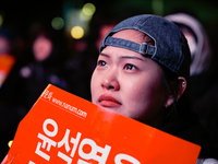 Citizens shed tears after the motion to impeach President Yoon Suk Yeol is rejected in the National Assembly. On December 7, 2024, nearly on...