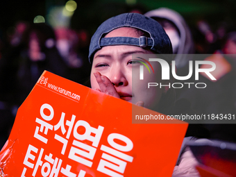 Citizens shed tears after the motion to impeach President Yoon Suk Yeol is rejected in the National Assembly. On December 7, 2024, nearly on...