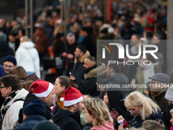 The entrance of the Cologne Dom Christmas Market in Cologne, Germany, on December 7, 2024, is completely packed with visitors. (