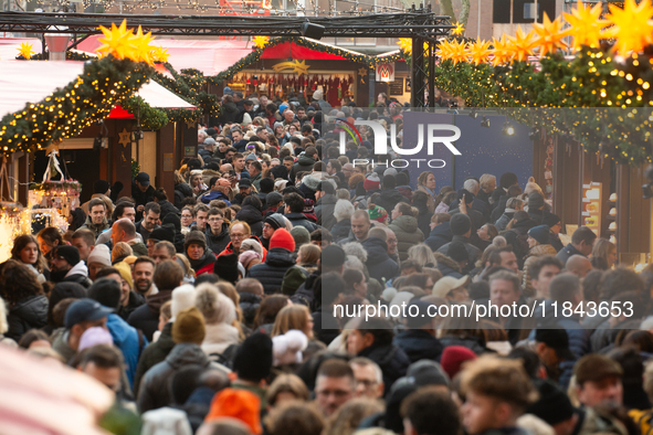 The Cologne Dom Christmas Market in Cologne, Germany, is completely packed with visitors on December 7, 2024. 