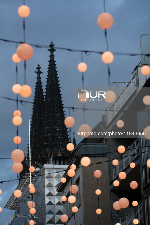 Christmas light decorations hang with the Dom Cathedral in the background in Cologne, Germany, on December 7, 2024. 