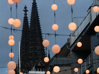 Christmas light decorations hang with the Dom Cathedral in the background in Cologne, Germany, on December 7, 2024. (