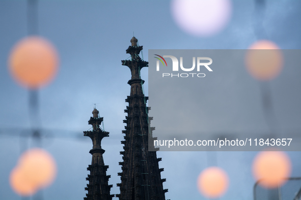 Christmas light decorations hang with the Dom Cathedral in the background in Cologne, Germany, on December 7, 2024. 