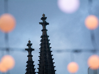 Christmas light decorations hang with the Dom Cathedral in the background in Cologne, Germany, on December 7, 2024. (