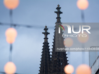 Christmas light decorations hang as Dom Cathedral is seen in the background in Cologne, Germany, on December 7, 2024. (