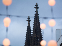 Christmas light decorations hang as Dom Cathedral is seen in the background in Cologne, Germany, on December 7, 2024. (