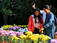 Visitors attend the 38th Chrysanthemum Flower Exhibition at Rajasthan University in Jaipur, Rajasthan, India, on December 7, 2024. (