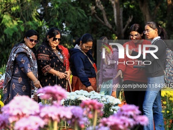 Visitors attend the 38th Chrysanthemum Flower Exhibition at Rajasthan University in Jaipur, Rajasthan, India, on December 7, 2024. (