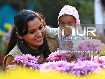 Visitors attend the 38th Chrysanthemum Flower Exhibition at Rajasthan University in Jaipur, Rajasthan, India, on December 7, 2024. (