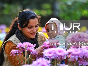 Visitors attend the 38th Chrysanthemum Flower Exhibition at Rajasthan University in Jaipur, Rajasthan, India, on December 7, 2024. (