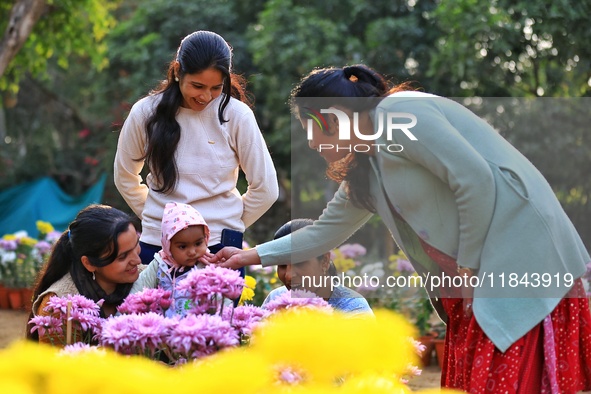 Visitors attend the 38th Chrysanthemum Flower Exhibition at Rajasthan University in Jaipur, Rajasthan, India, on December 7, 2024. 