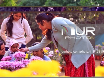 Visitors attend the 38th Chrysanthemum Flower Exhibition at Rajasthan University in Jaipur, Rajasthan, India, on December 7, 2024. (