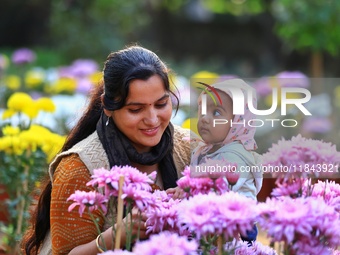 Visitors attend the 38th Chrysanthemum Flower Exhibition at Rajasthan University in Jaipur, Rajasthan, India, on December 7, 2024. (