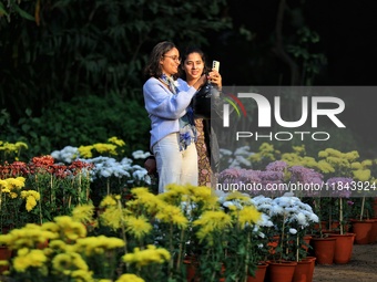 Visitors attend the 38th Chrysanthemum Flower Exhibition at Rajasthan University in Jaipur, Rajasthan, India, on December 7, 2024. (