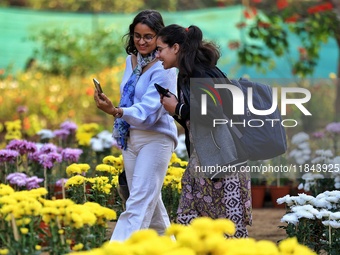 Visitors attend the 38th Chrysanthemum Flower Exhibition at Rajasthan University in Jaipur, Rajasthan, India, on December 7, 2024. (