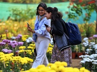 Visitors attend the 38th Chrysanthemum Flower Exhibition at Rajasthan University in Jaipur, Rajasthan, India, on December 7, 2024. (