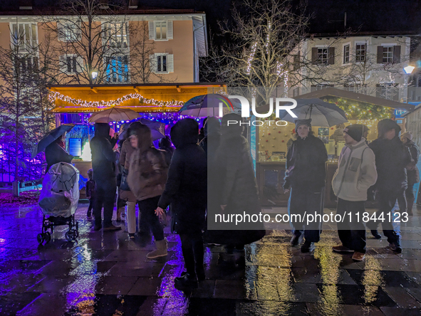 Umbrellas adorn the festive scene in Starnberg, Bavaria, Germany, on December 7, 2024, as the Christmas market embraces the charm of a rainy...