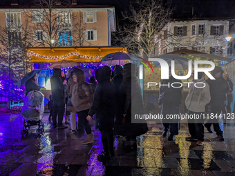 Umbrellas adorn the festive scene in Starnberg, Bavaria, Germany, on December 7, 2024, as the Christmas market embraces the charm of a rainy...