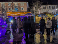 Umbrellas adorn the festive scene in Starnberg, Bavaria, Germany, on December 7, 2024, as the Christmas market embraces the charm of a rainy...