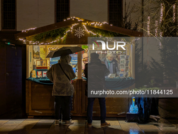 Umbrellas adorn the festive scene in Starnberg, Bavaria, Germany, on December 7, 2024, as the Christmas market embraces the charm of a rainy...