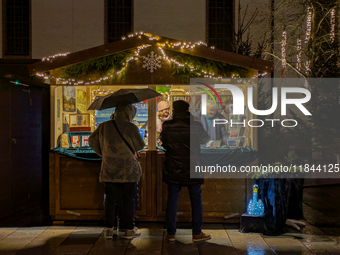 Umbrellas adorn the festive scene in Starnberg, Bavaria, Germany, on December 7, 2024, as the Christmas market embraces the charm of a rainy...