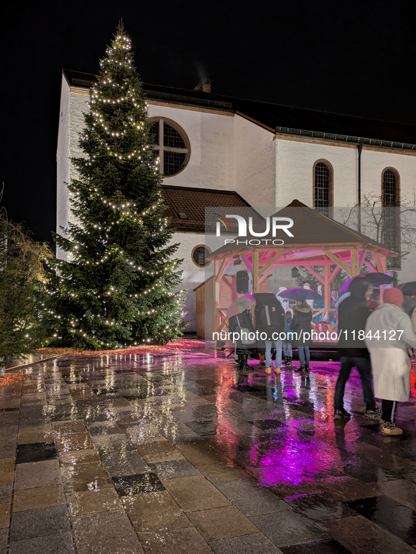 Umbrellas adorn the festive scene in Starnberg, Bavaria, Germany, on December 7, 2024, as the Christmas market embraces the charm of a rainy...