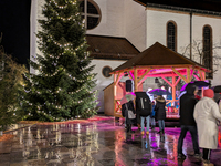 Umbrellas adorn the festive scene in Starnberg, Bavaria, Germany, on December 7, 2024, as the Christmas market embraces the charm of a rainy...