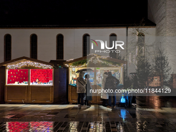 Umbrellas adorn the festive scene in Starnberg, Bavaria, Germany, on December 7, 2024, as the Christmas market embraces the charm of a rainy...